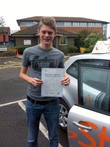 Adam with his Practical Driving Test Pass Certificate outside Weston-super-Mare Driving Test Centre